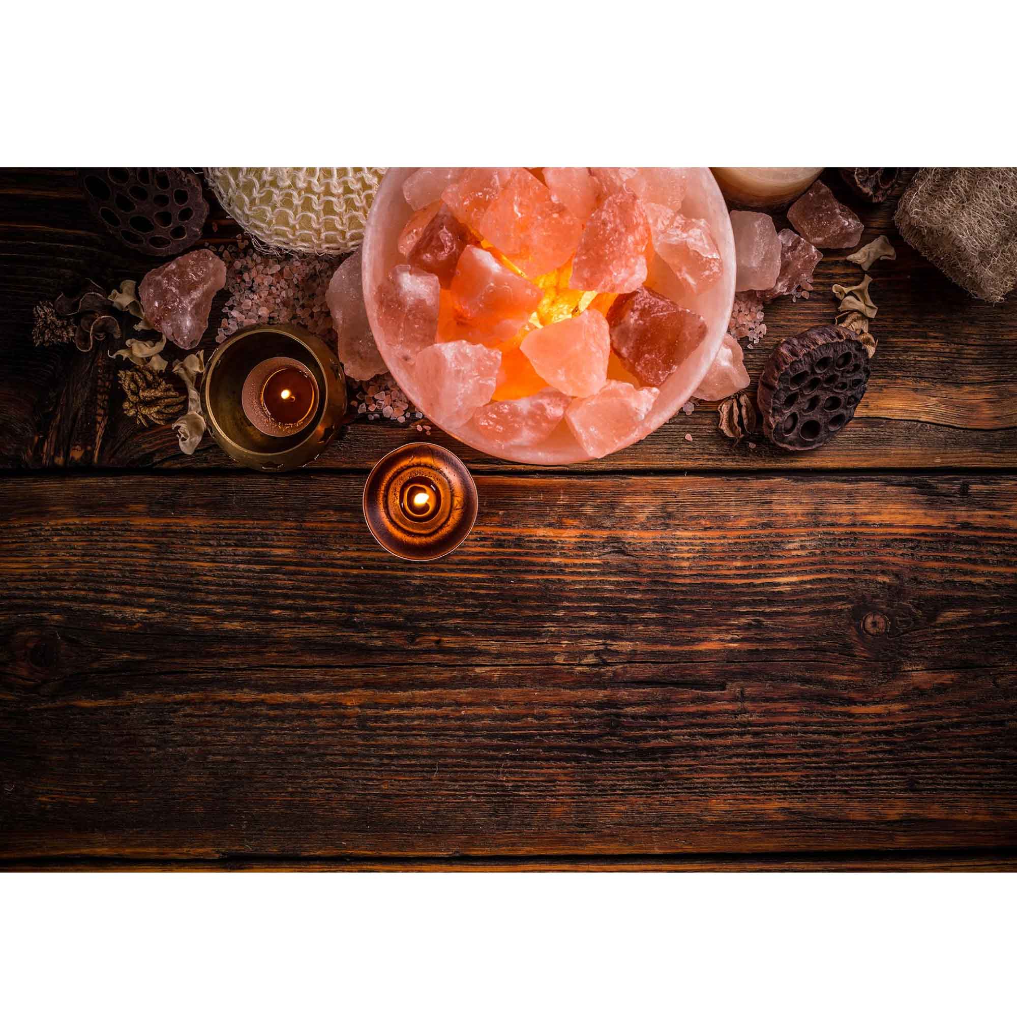 Glowing Himalayan pink salt fire bowl lamp with carved crystal rocks on tabletop