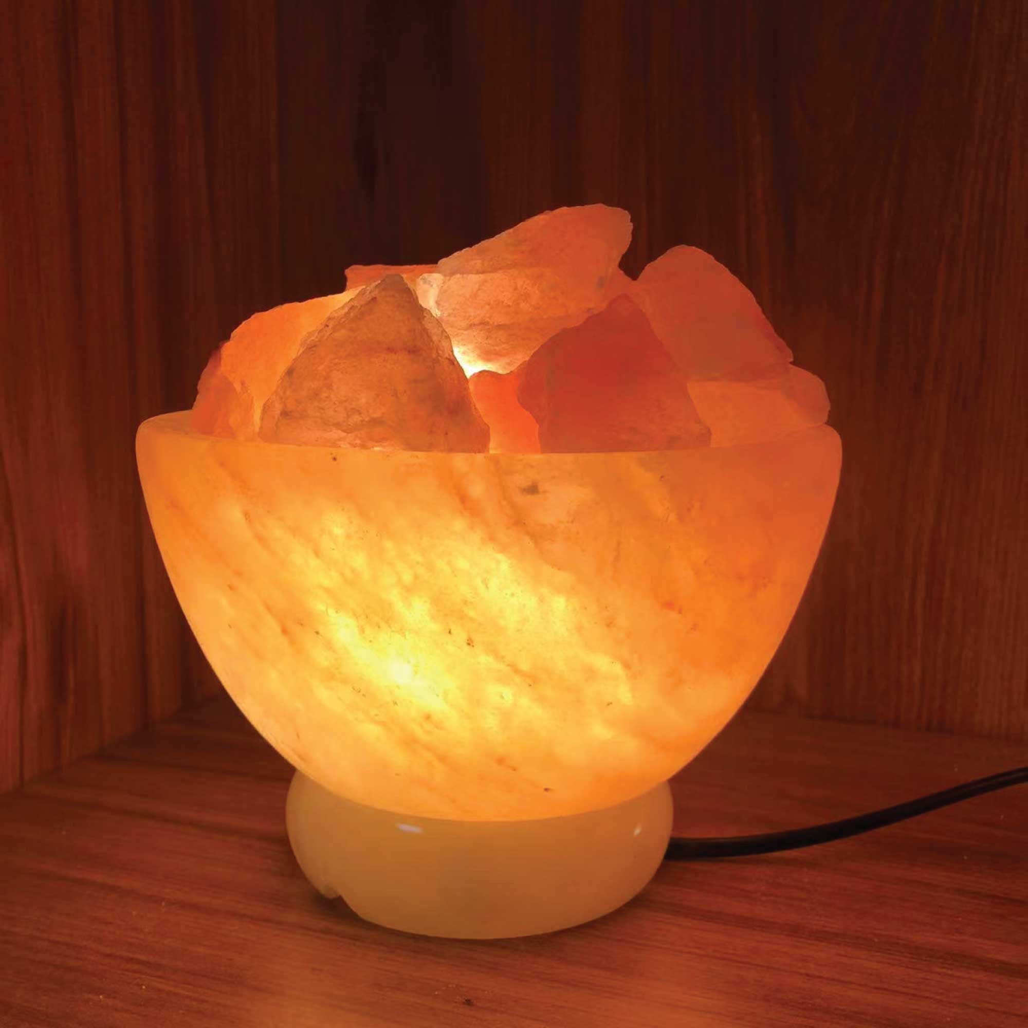 Himalayan pink salt fire bowl lamp with carved crystal rocks, glowing warm light