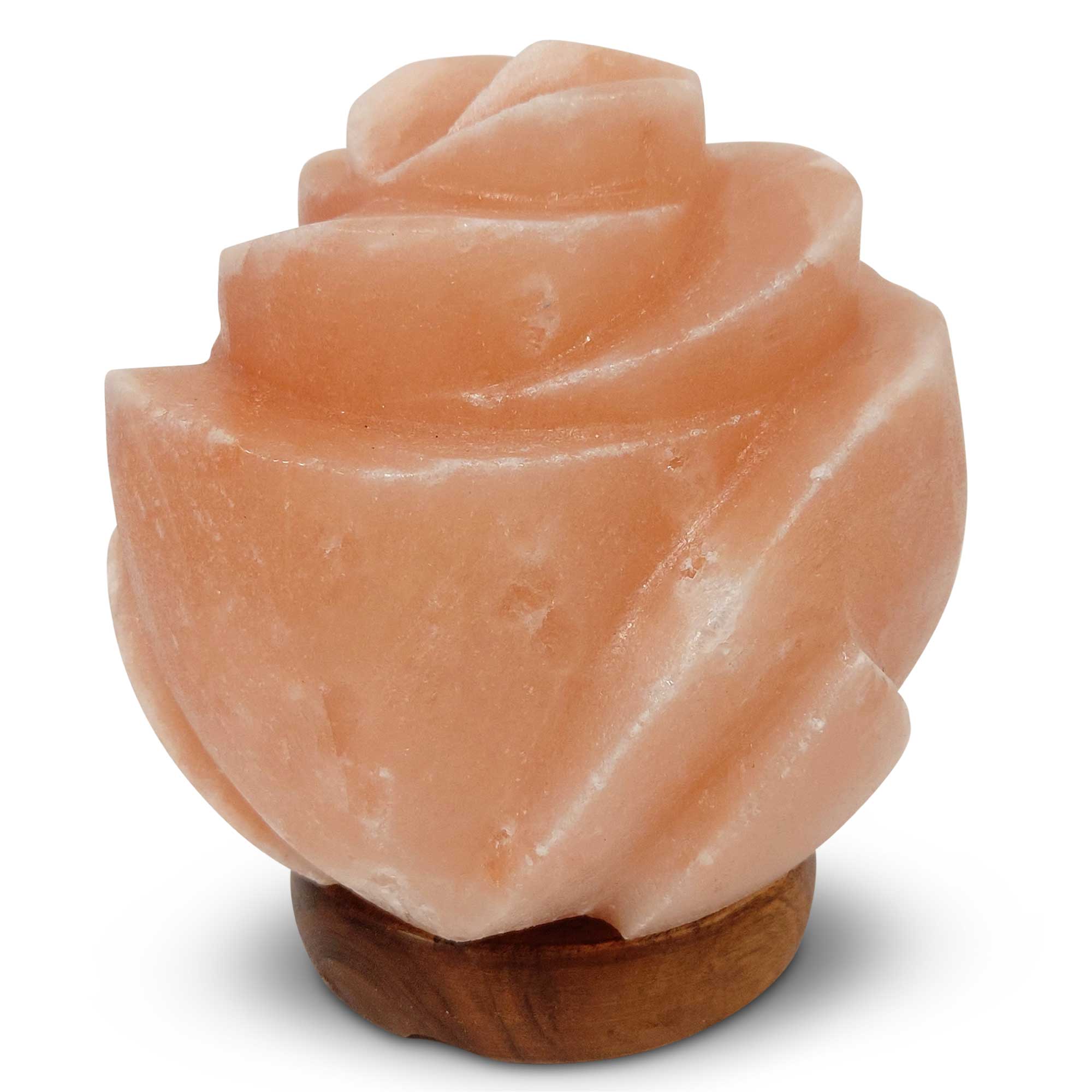 Front view of carved pink salt lamp in flower design on dark wooden base, unlit