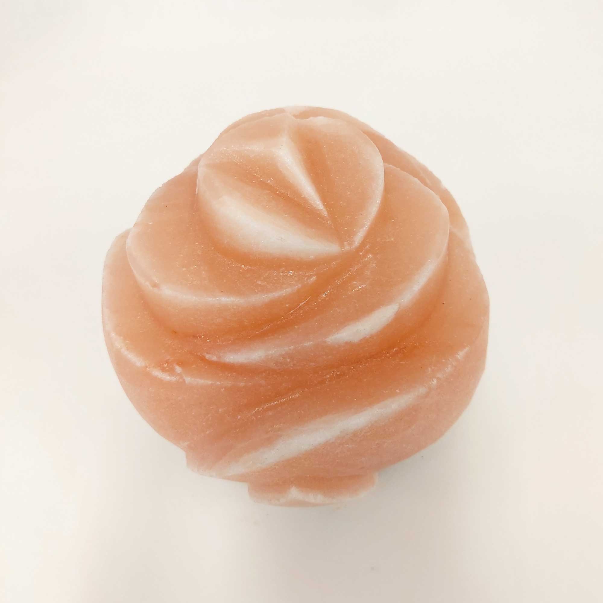 Close-up of carved pink salt lamp in flower design, unlit