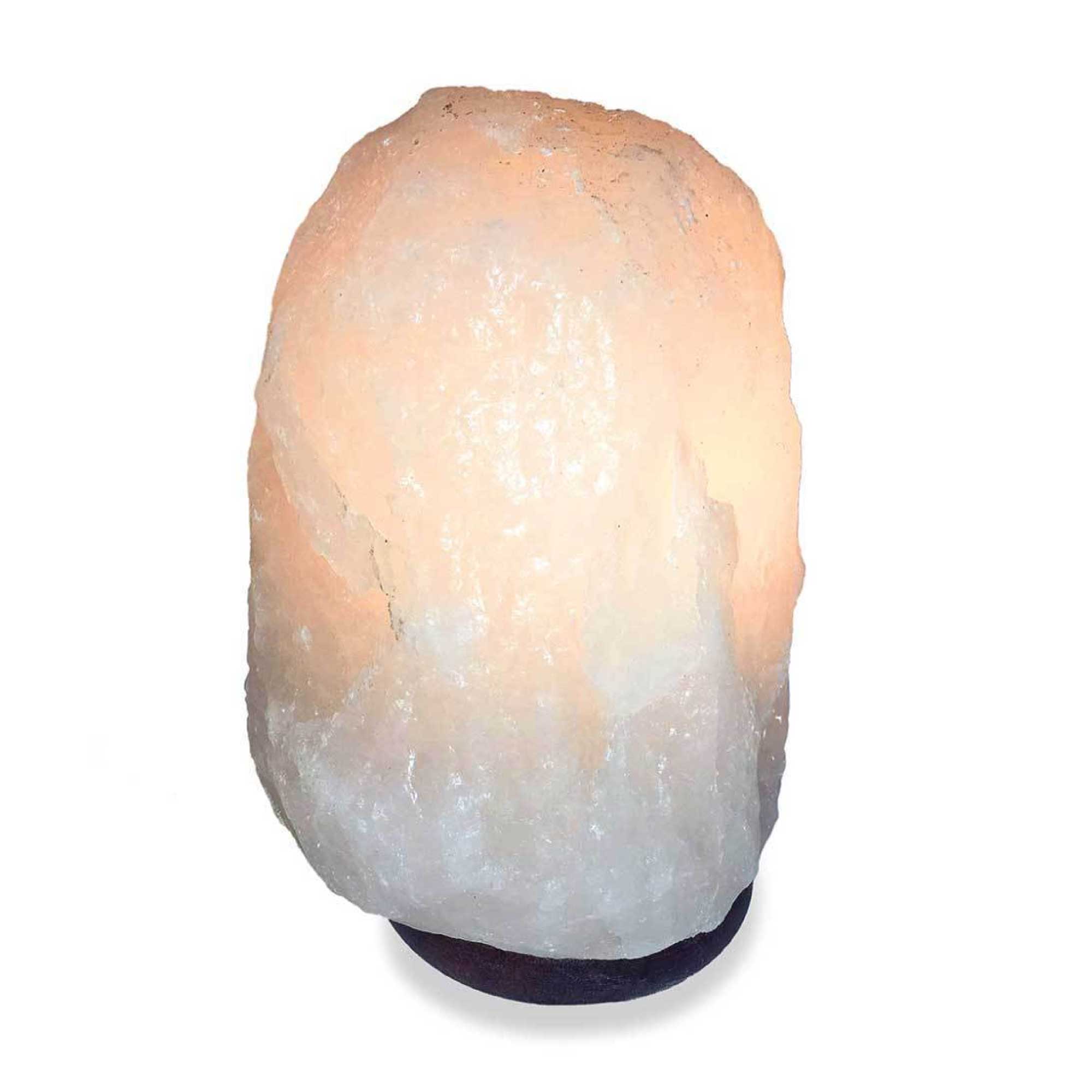 Himalayan white salt lamp in natural crystal rock shape with dark base.
