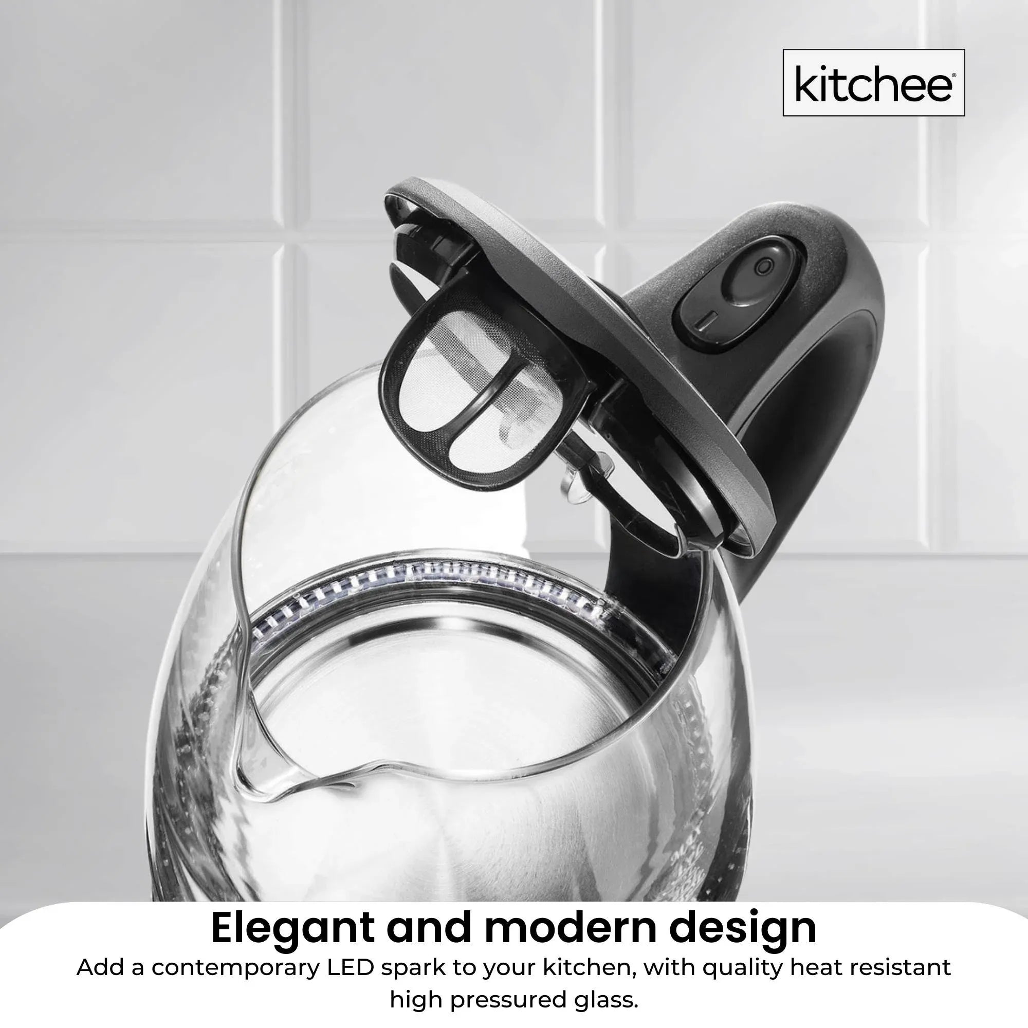 Glass electric kettle with black lid and push-open handle, close-up top view
