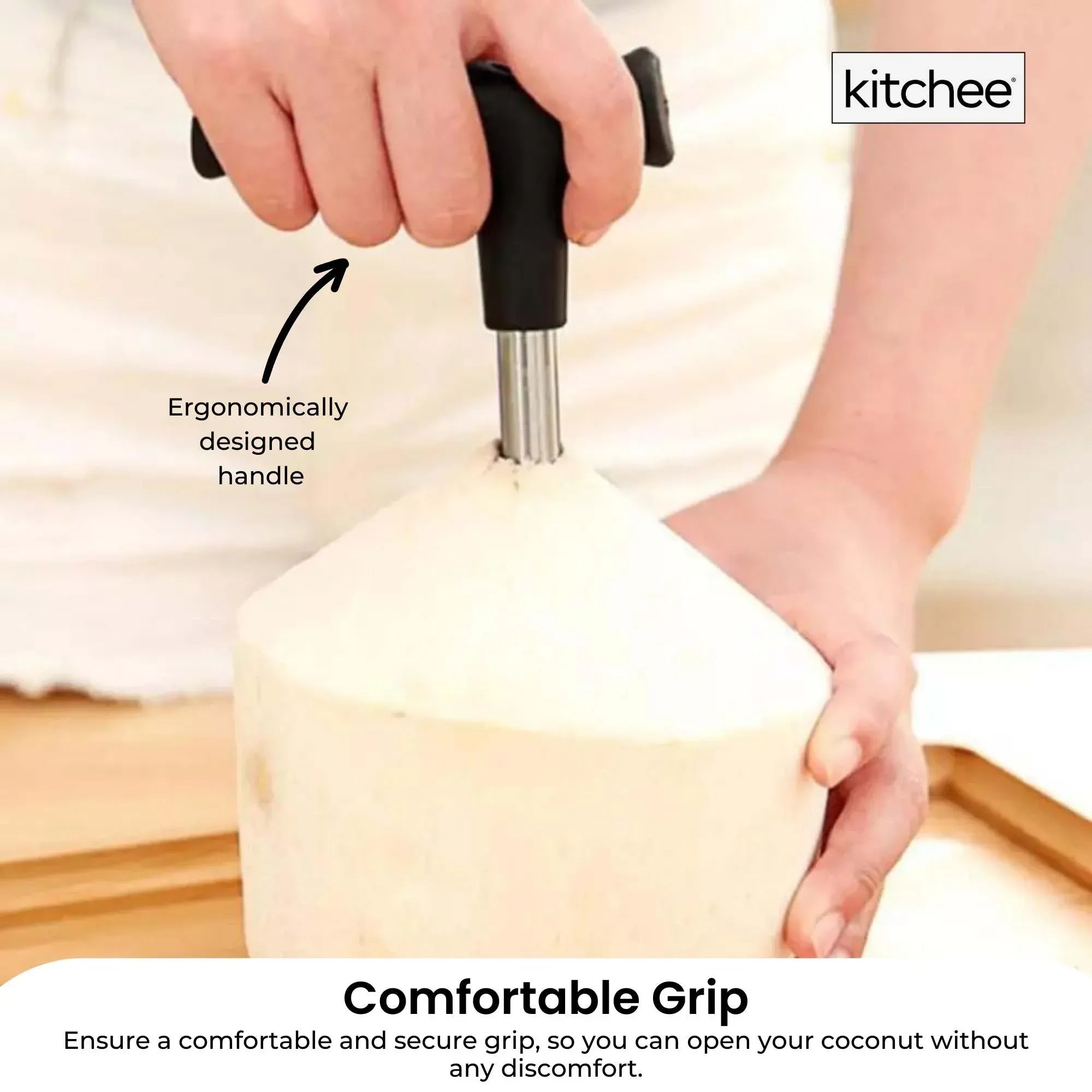 Ergonomic black handle coconut opener with stainless steel rod inserted into coconut