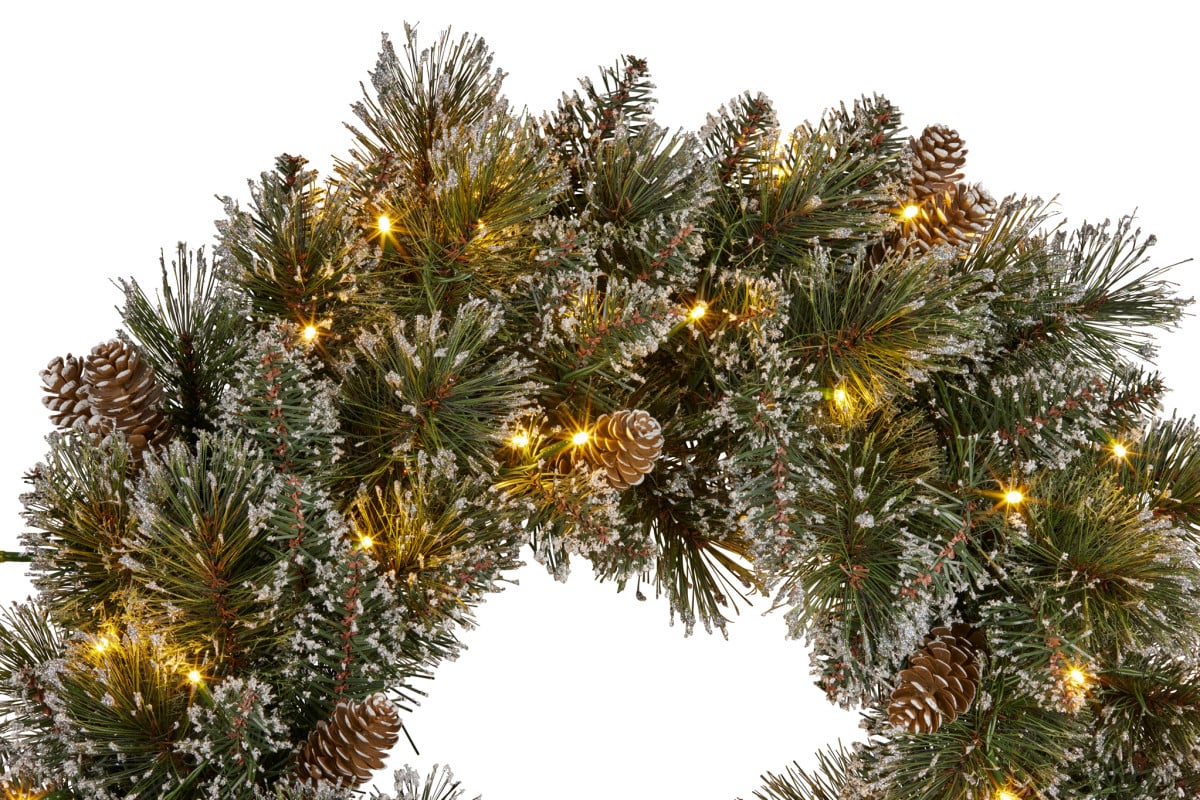 Close-up Christmas pine wreath with warm white LED lights and pinecones