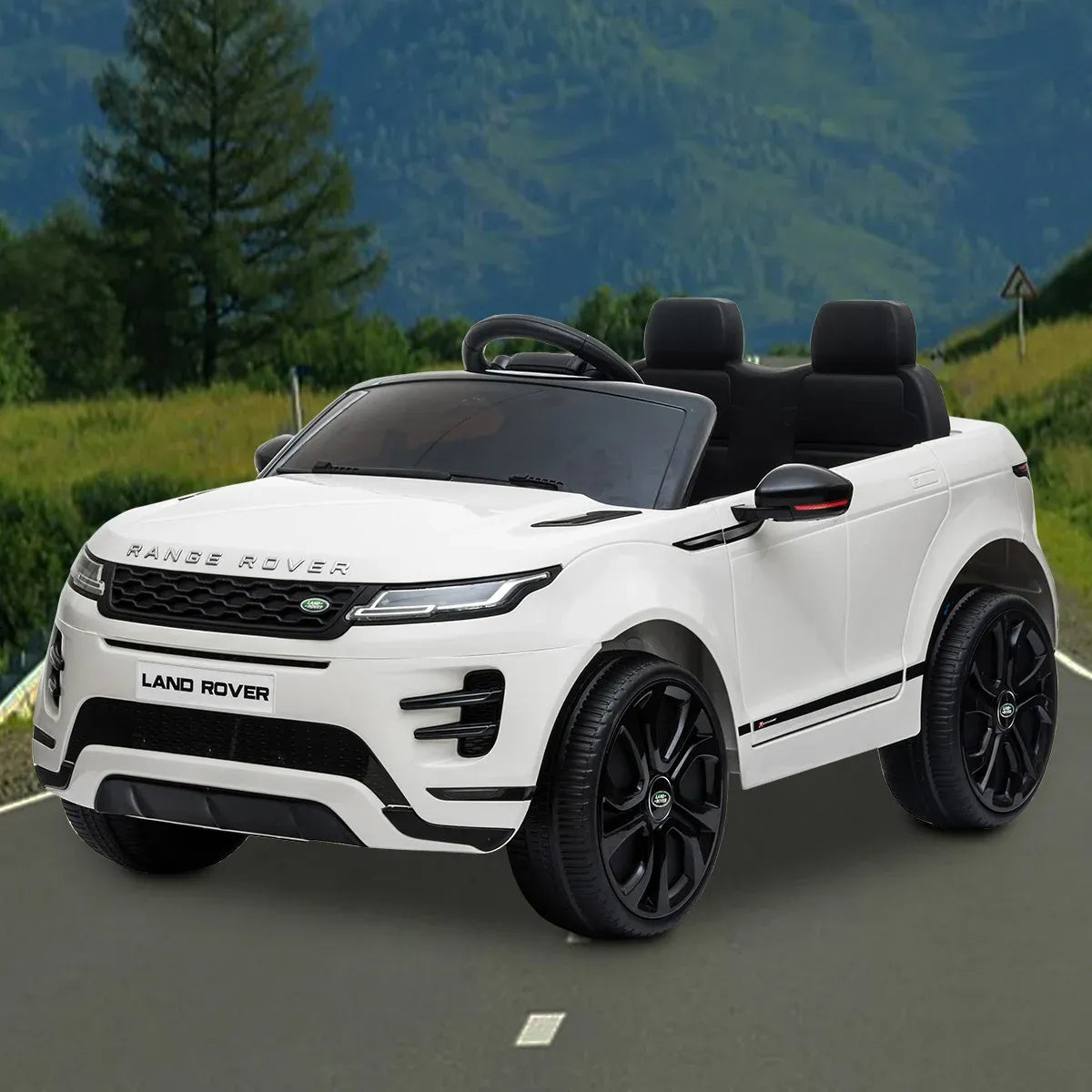 White kids electric ride-on SUV on outdoor path with black wheels and front grille