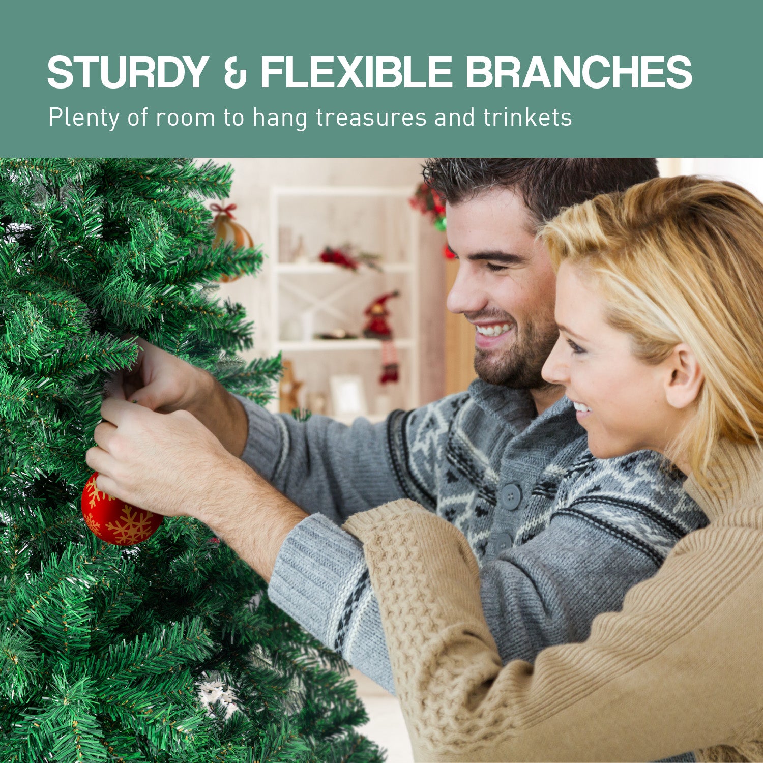 Artificial green Christmas tree branches being decorated with ornaments