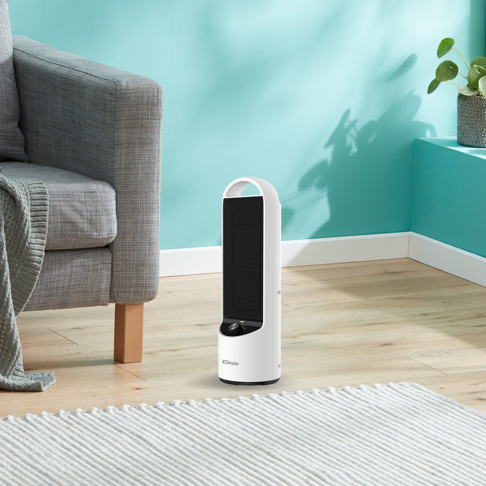 Dimplex DC ceramic heater on carpeted floor, white body with black grille and top handle.