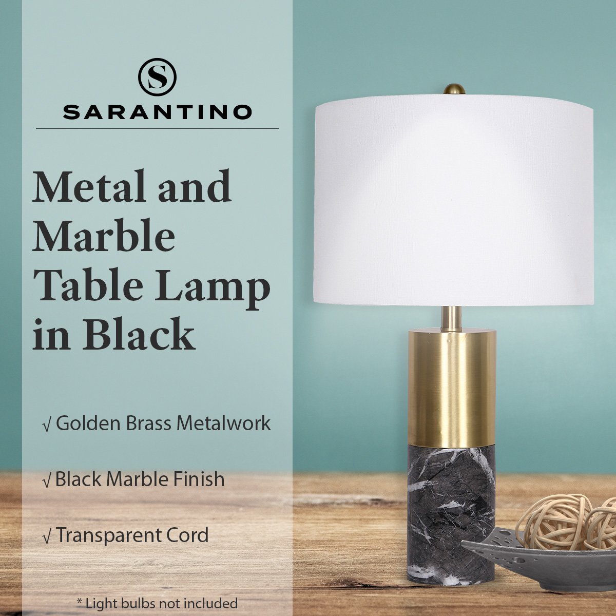 Table lamp with white shade and brass metalwork on black marble base