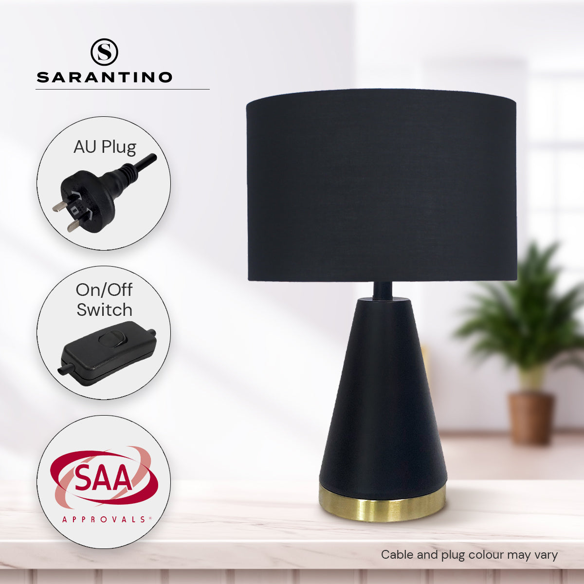 Black fabric drum table lamp with tapered metal base and gold bottom ring.