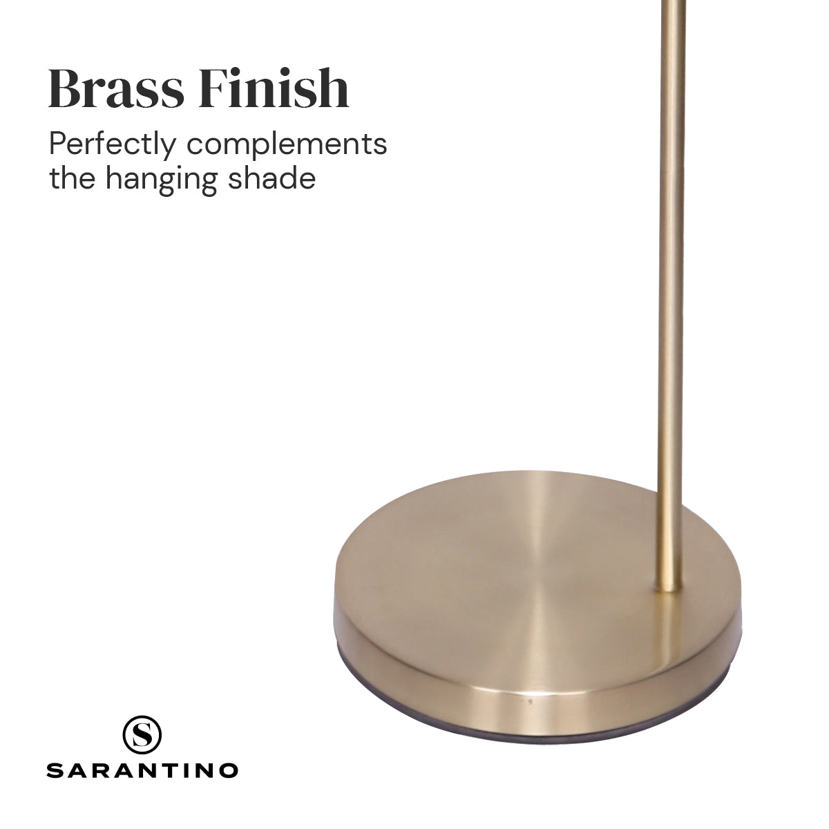 Brass round base of a modern arc floor lamp with vertical lamp pole