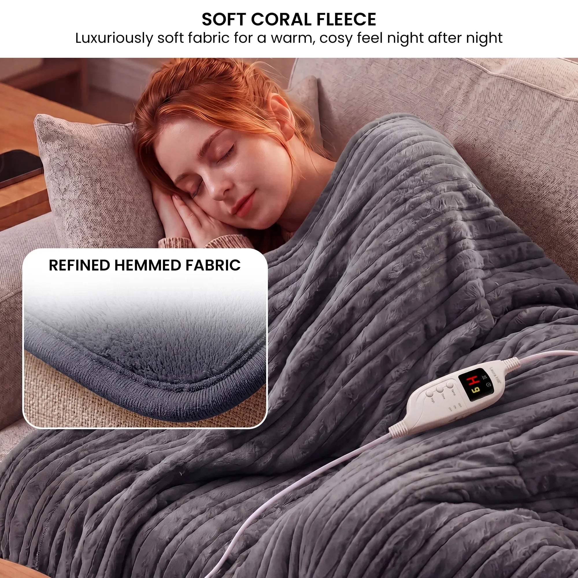 Grey heated throw blanket with controller on top edge and connected cord visible.