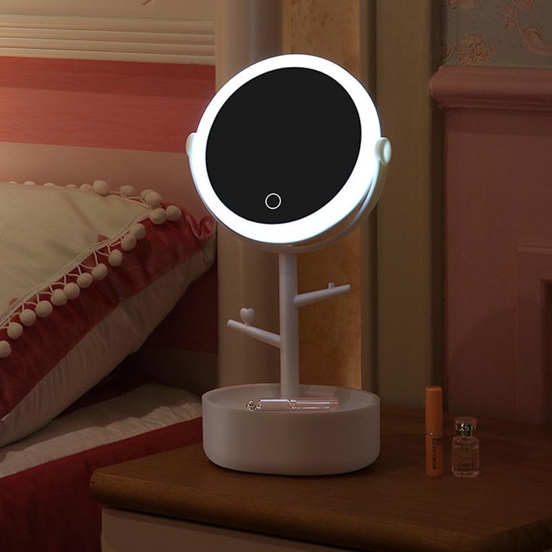 Pink LED light cosmetic mirror with round lit screen on desk stand