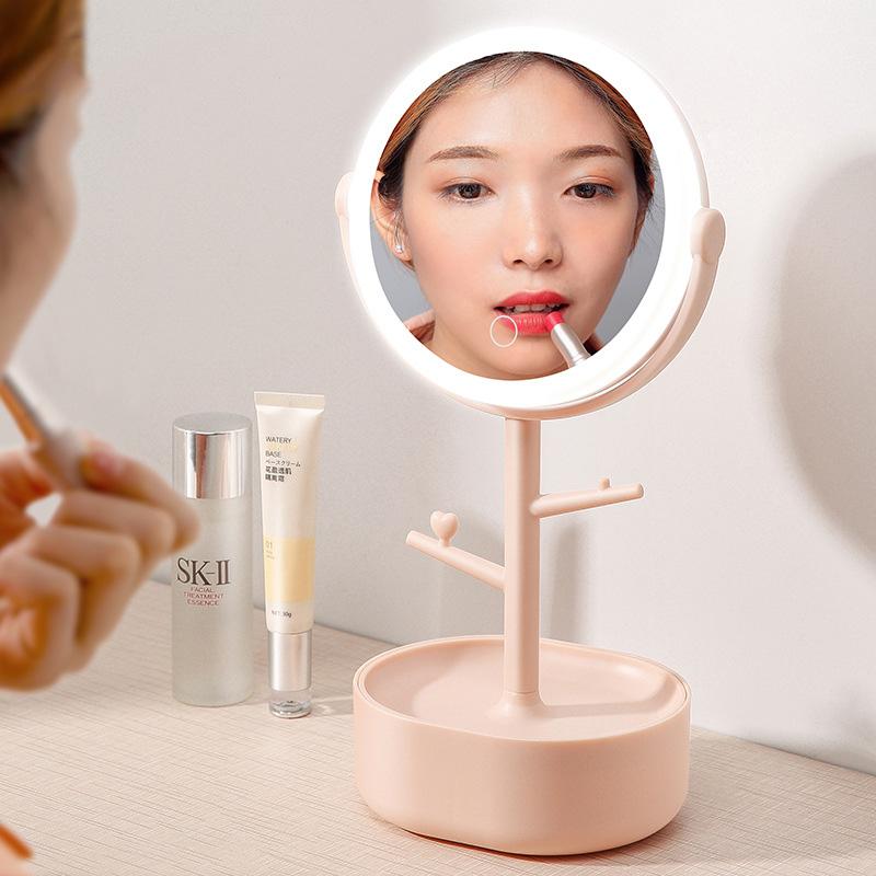 Pink LED light cosmetic mirror showing face reflection in illuminated ring