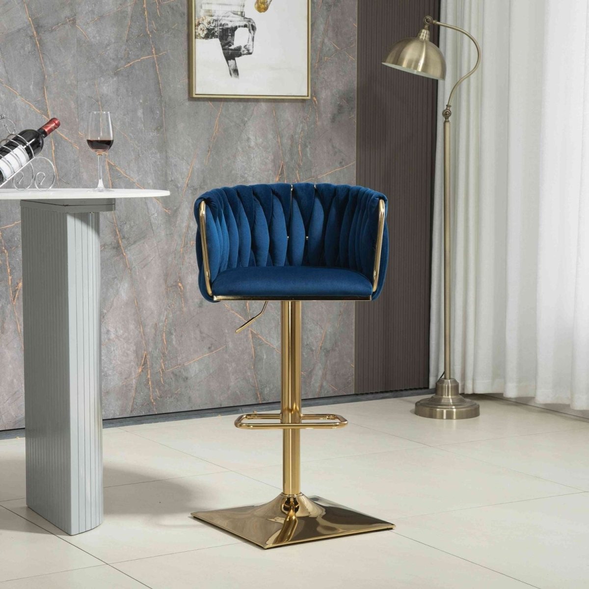 Navy velvet bar stool with tufted backrest, gold pedestal base and footrest