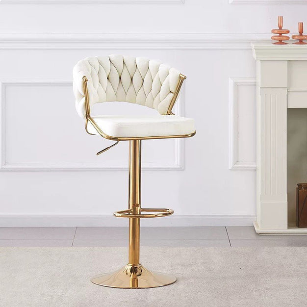 Beige tufted velvet bar stool with curved arms and round gold pedestal base