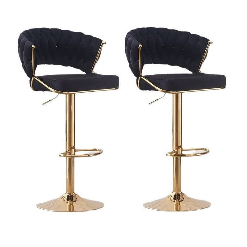 Pair of black velvet barstools with padded backs, upholstered seats, and gold bases