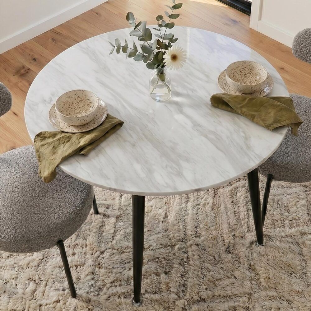 Round MDF marbling dining table with white-gray surface and black splayed legs