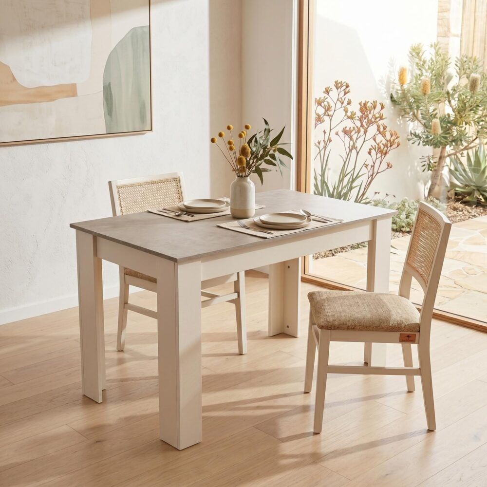 Rectangular dining table with grey stone-look top and white wooden legs, styled with place settings