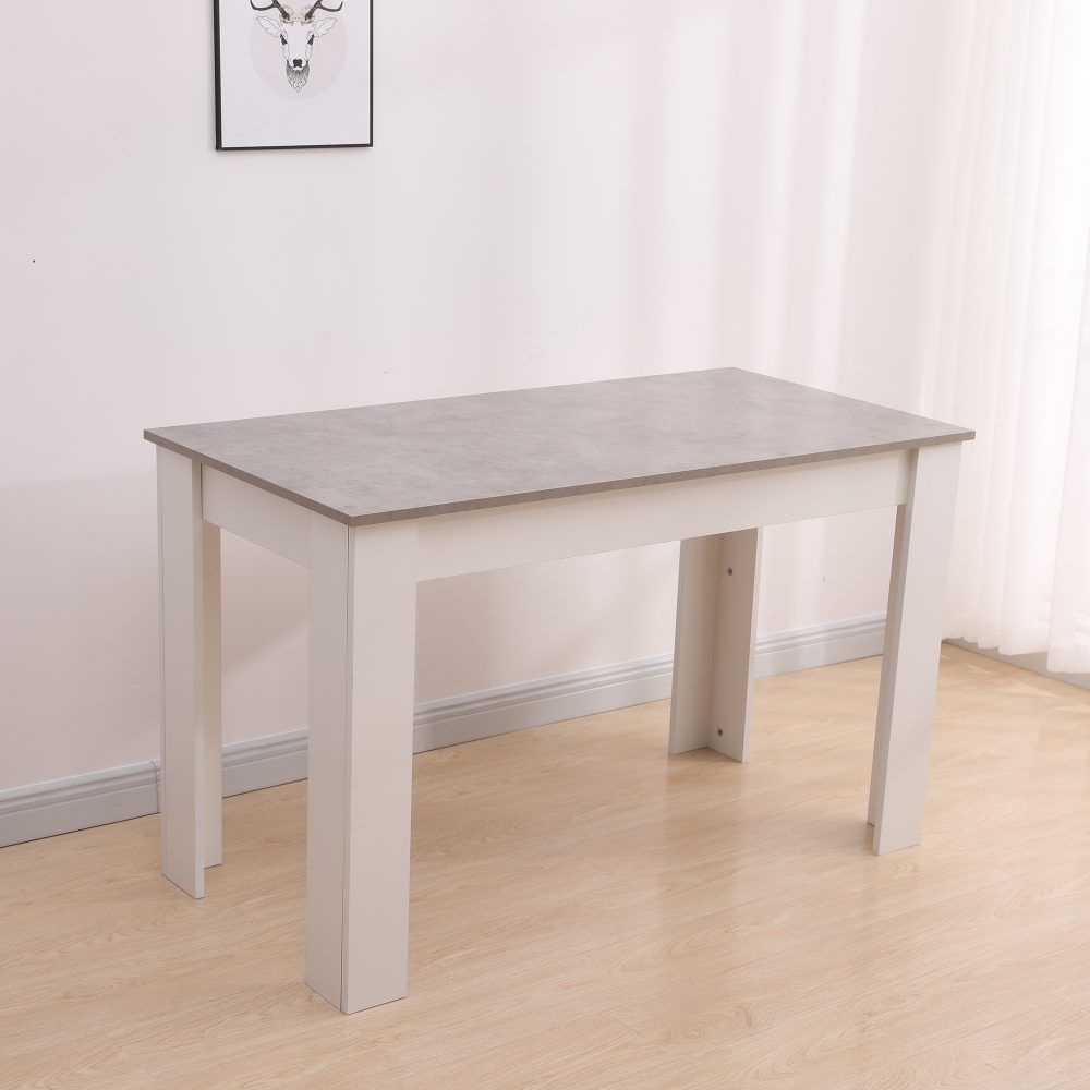 Rectangular dining table with grey tabletop and white legs, three-quarter view