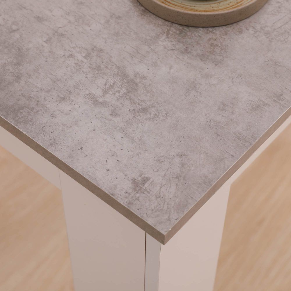 Close-up of grey tabletop with speckled texture and white side panel
