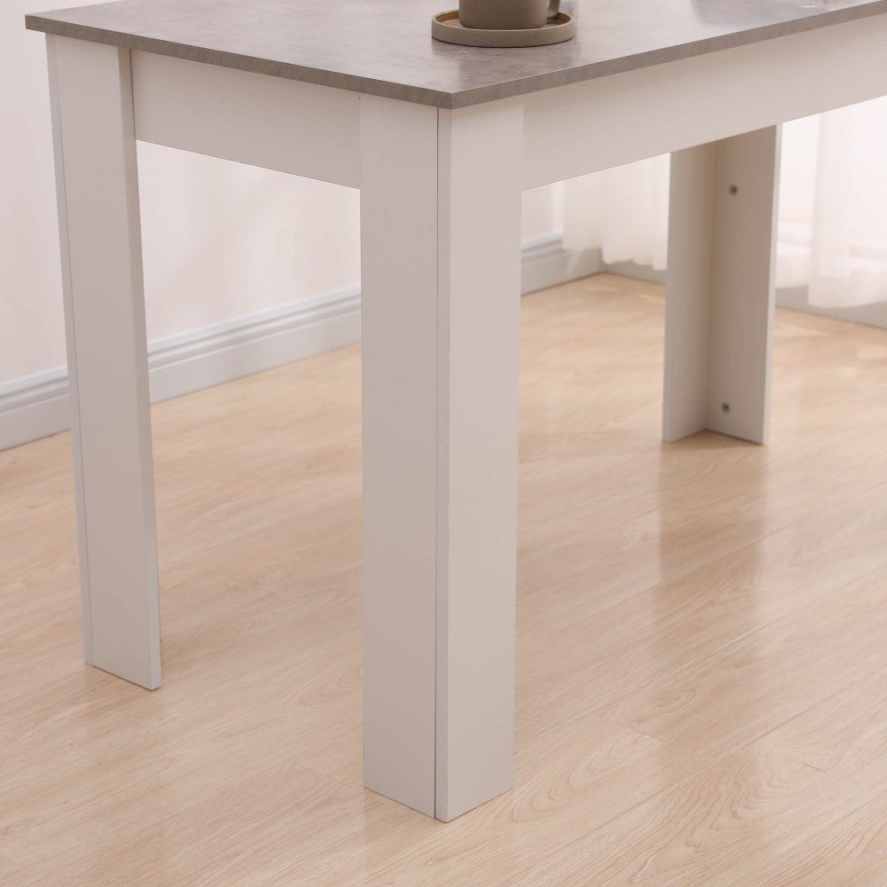 Close-up of white table legs with grey tabletop edge, dining table structure detail