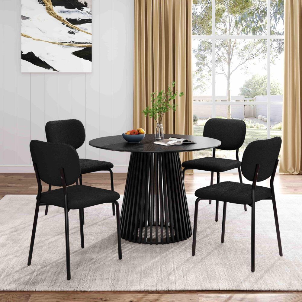 Round dining table with dark top and tall ribbed pedestal base