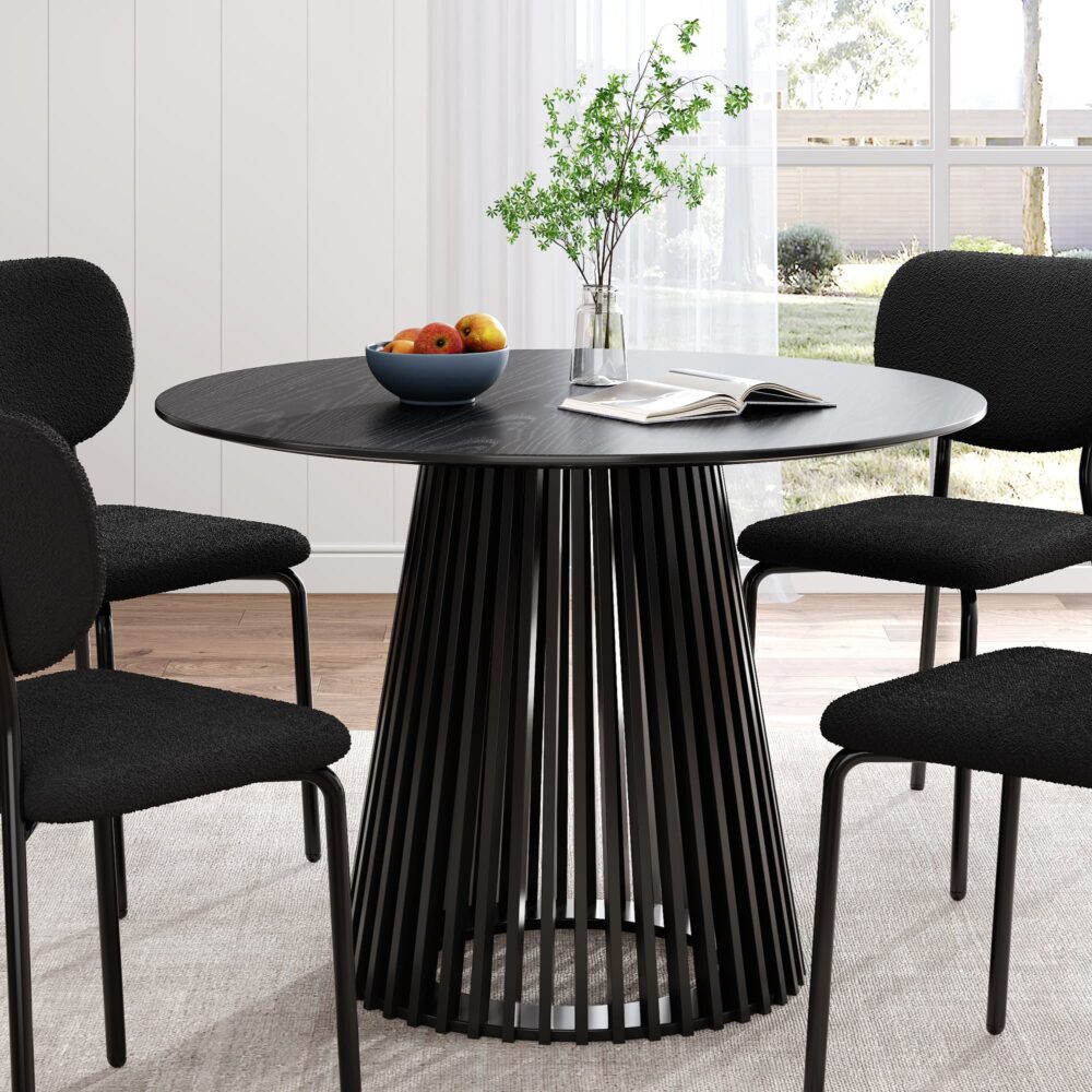 Round dining table with dark top and vertical slat pedestal base