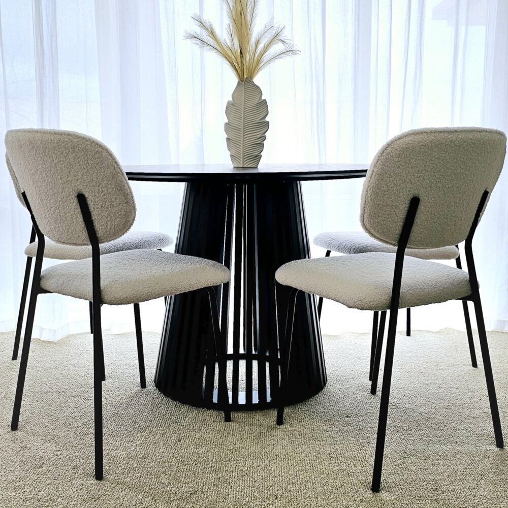 Round dining table with dark tabletop and ribbed pedestal base