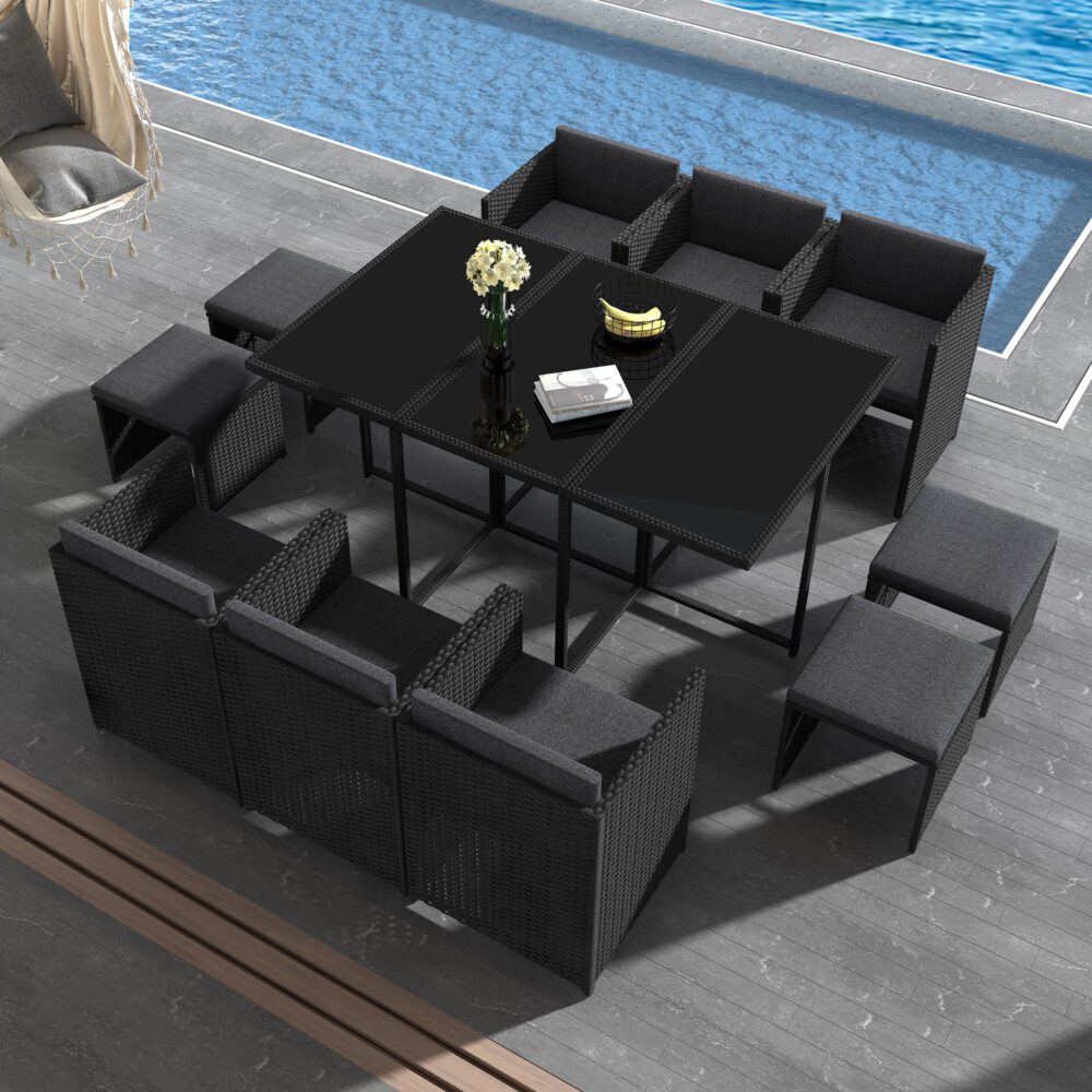 Black outdoor dining set with glass-top table, corner benches, and upholstered bench cushions