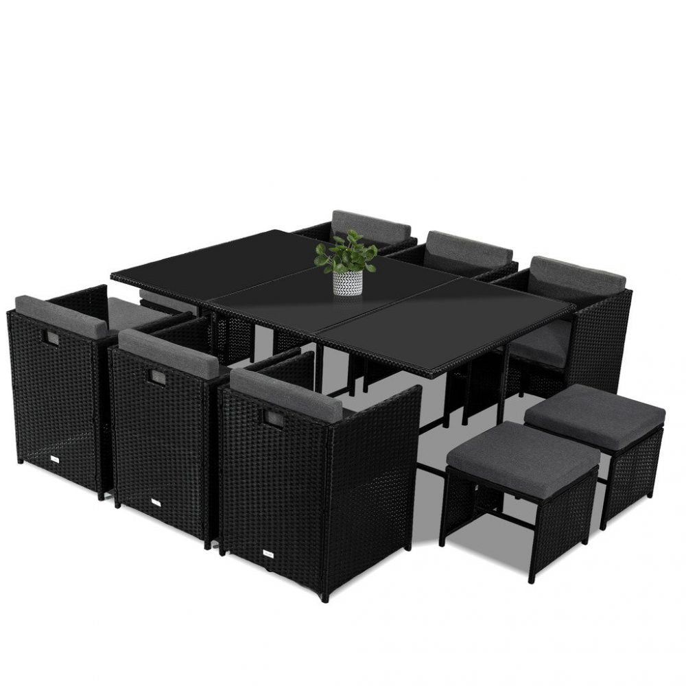 Black outdoor dining set with square glass-top table, corner benches, and four upholstered seat pads