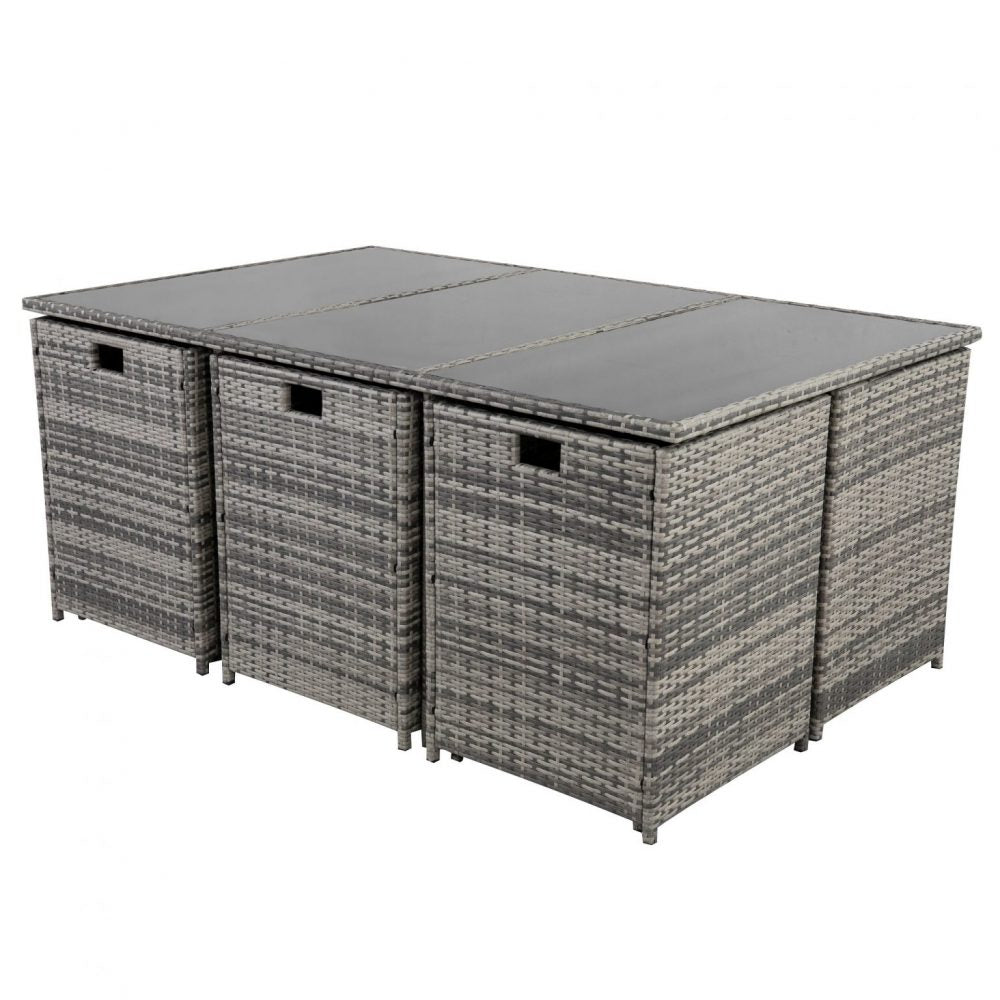 Grey outdoor dining set with rectangular glass-top table and woven side benches with cushions