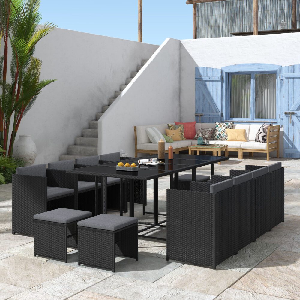 Black outdoor dining set with modular woven seats and rectangular glass dining table