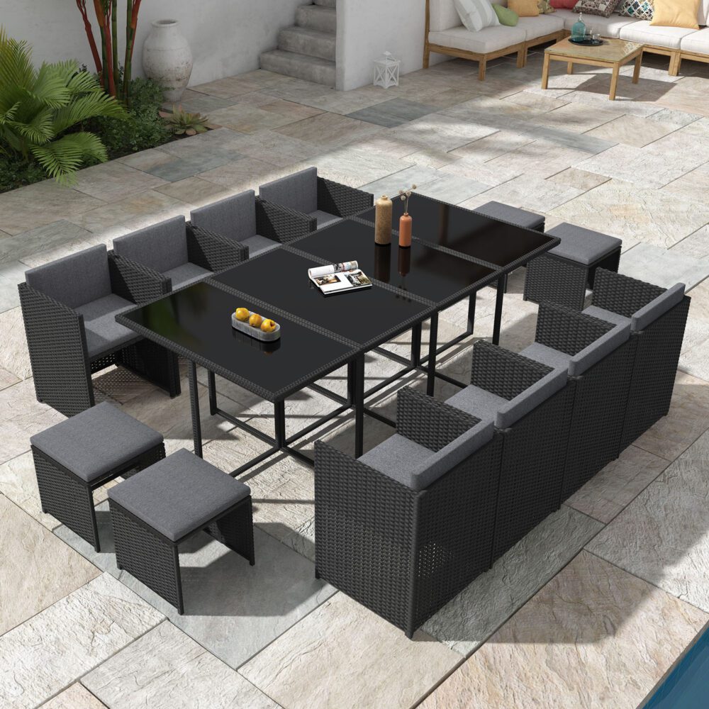 Black outdoor dining set with wide rectangular table and woven benches and chairs