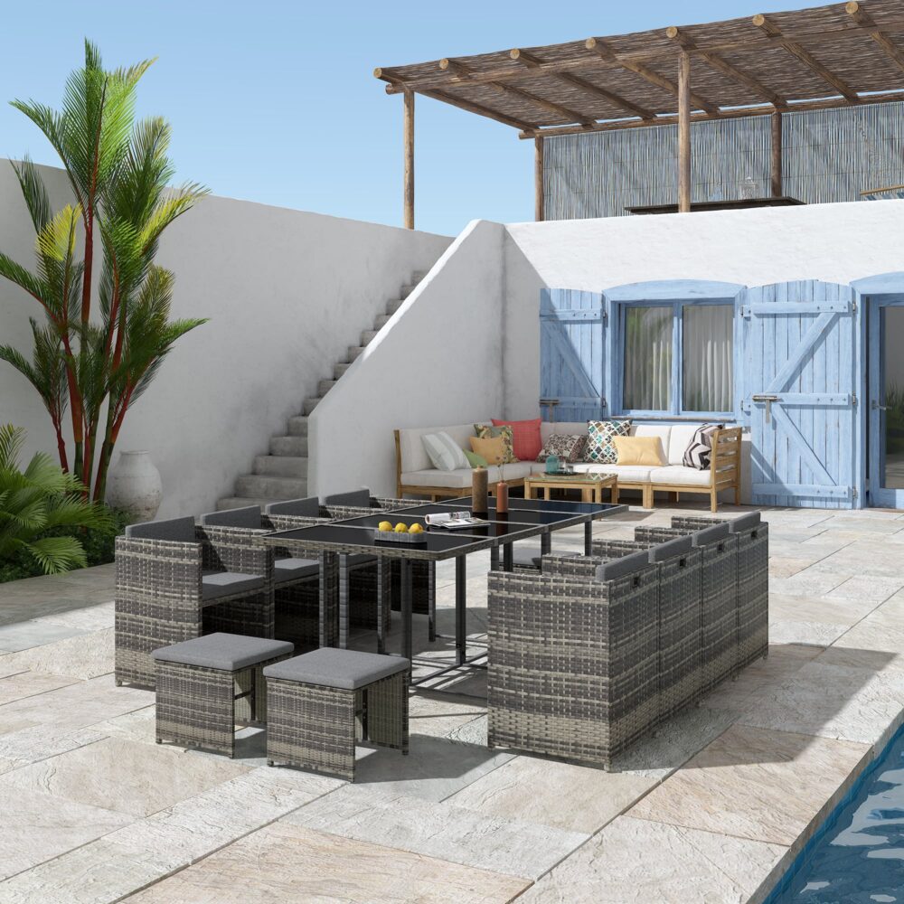 Grey outdoor dining set with rectangular table, matching benches, and woven ottomans