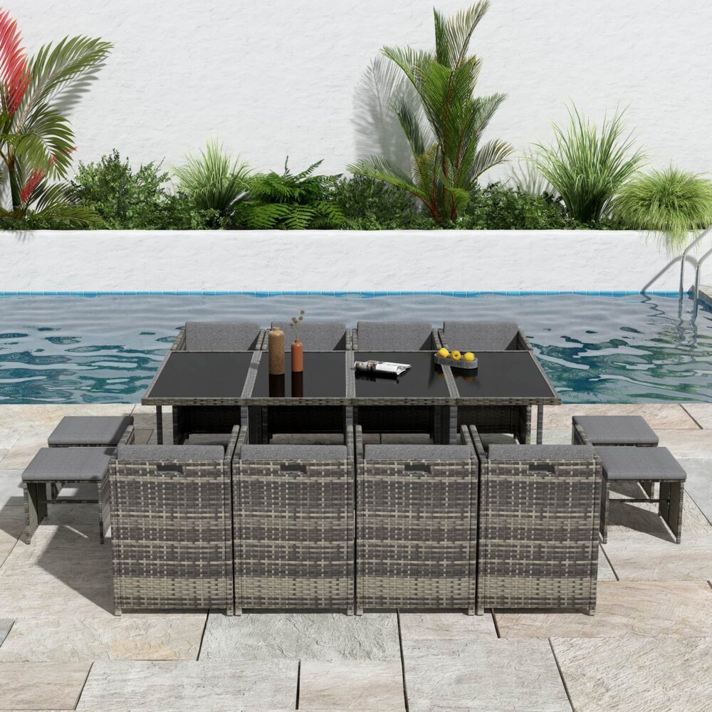 Grey outdoor dining set with rectangular table, woven chairs, and padded bench seats