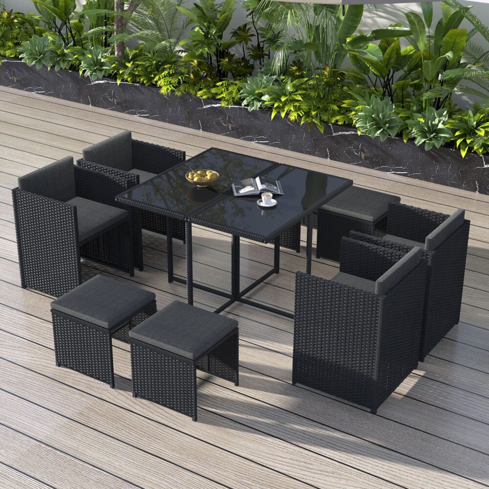 Black rattan outdoor dining set with rectangular table, cushioned chairs, and benches