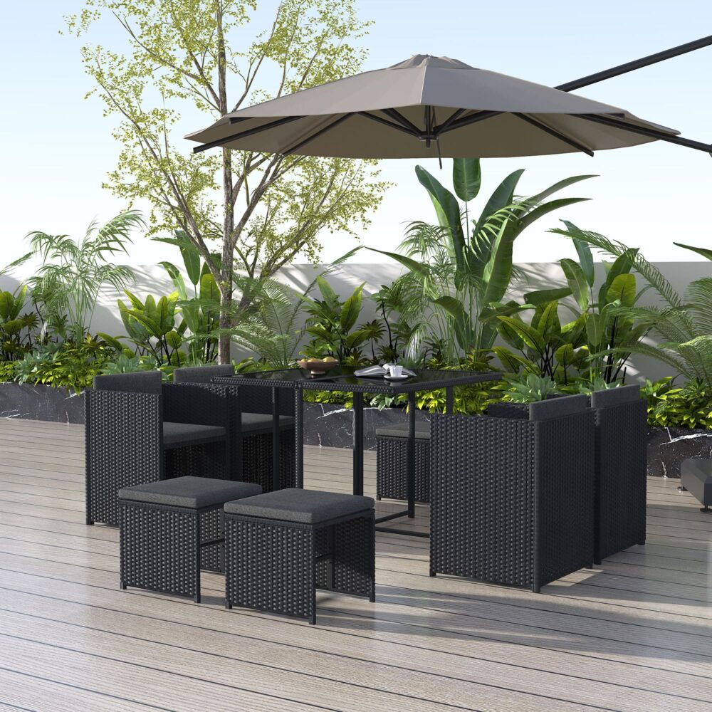 Black rattan outdoor dining set with rectangular table, cushioned seats, and umbrella