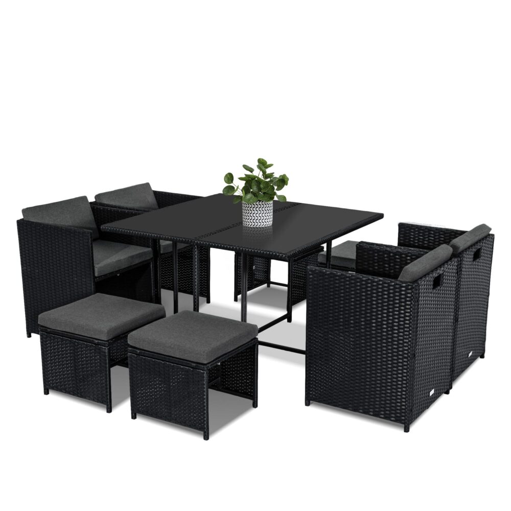 Black woven rattan dining set with rectangular table and cushioned ottoman seats