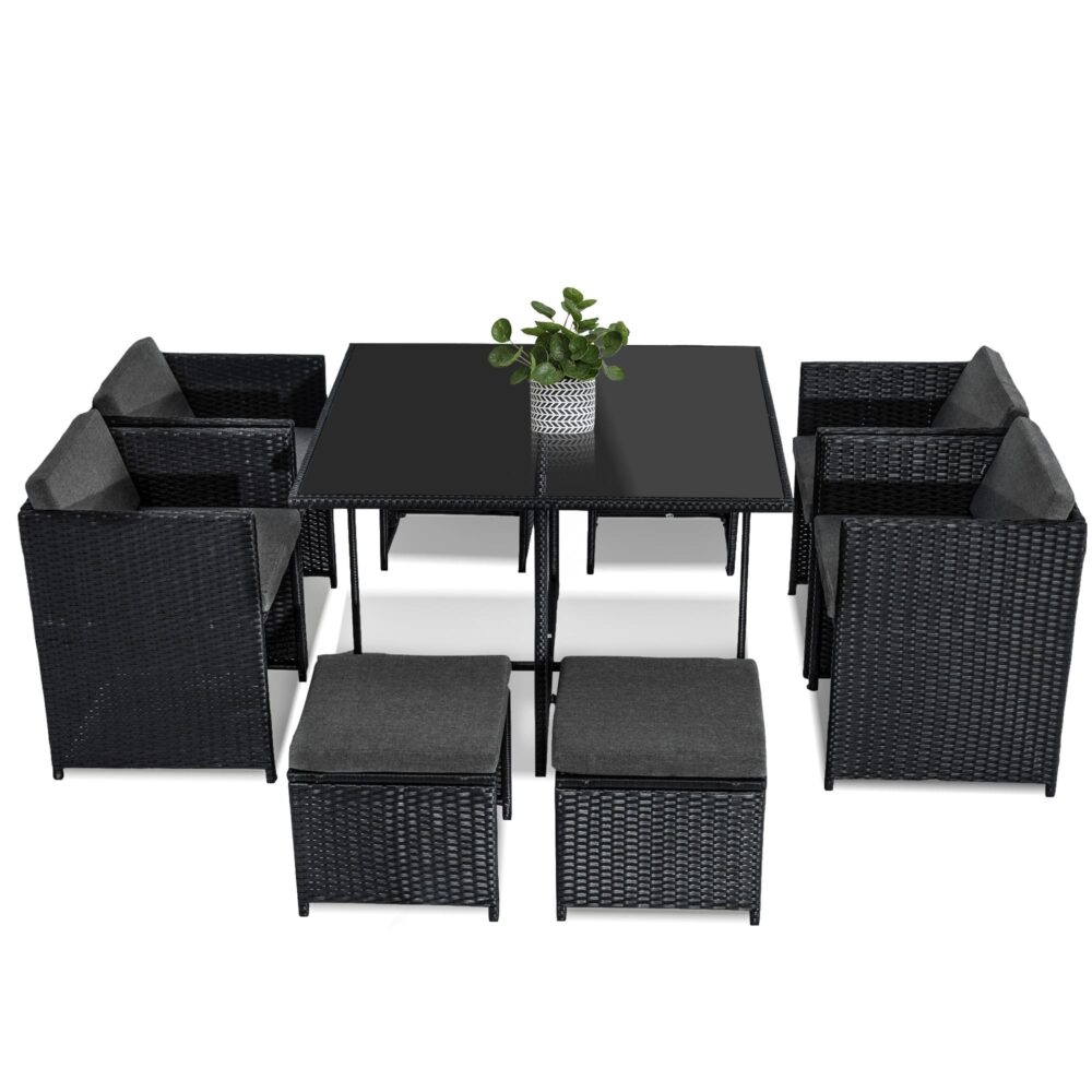 Black rattan outdoor dining set with table and cushioned chairs, top view