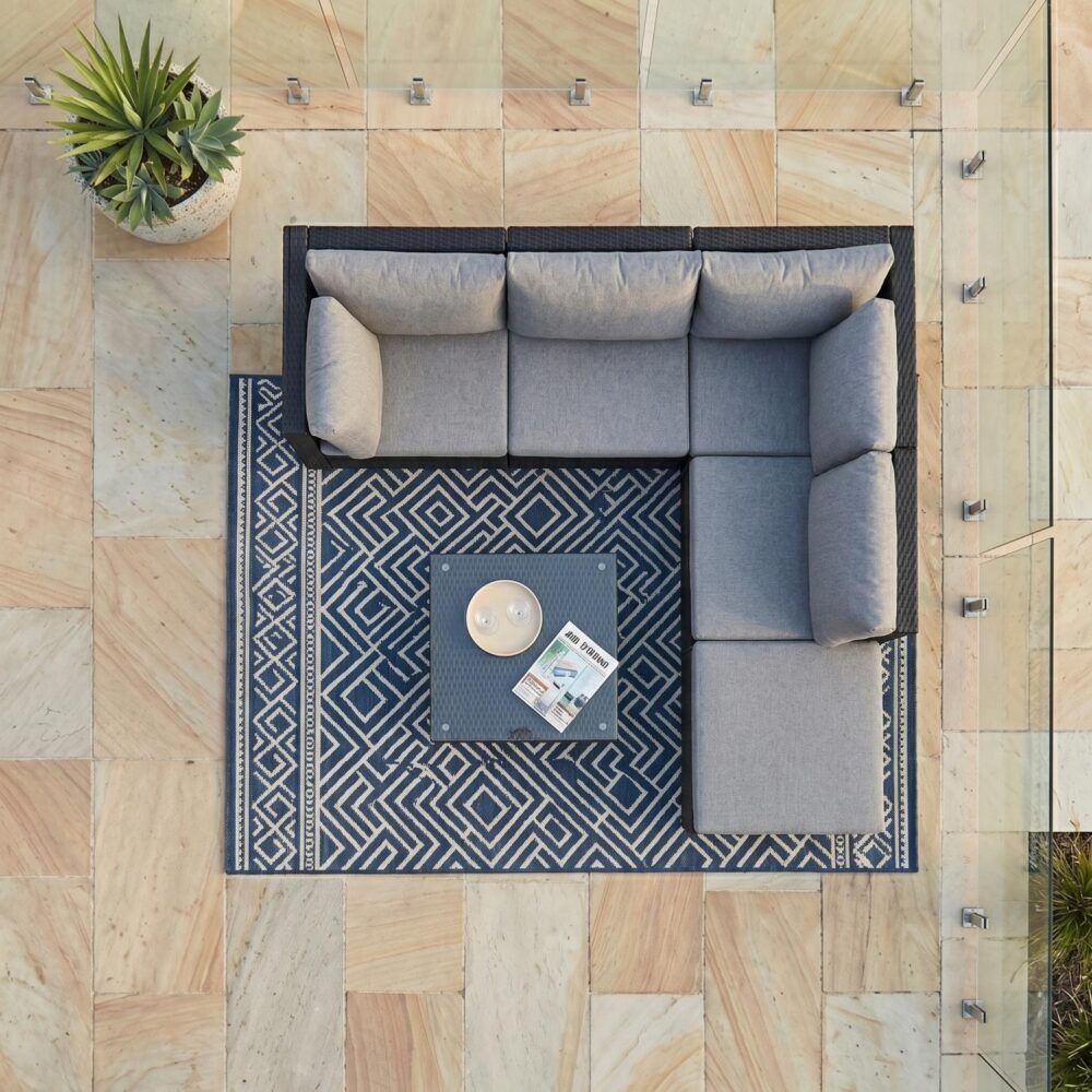Black sectional lounge set with gray cushions and matching ottoman coffee table, top view