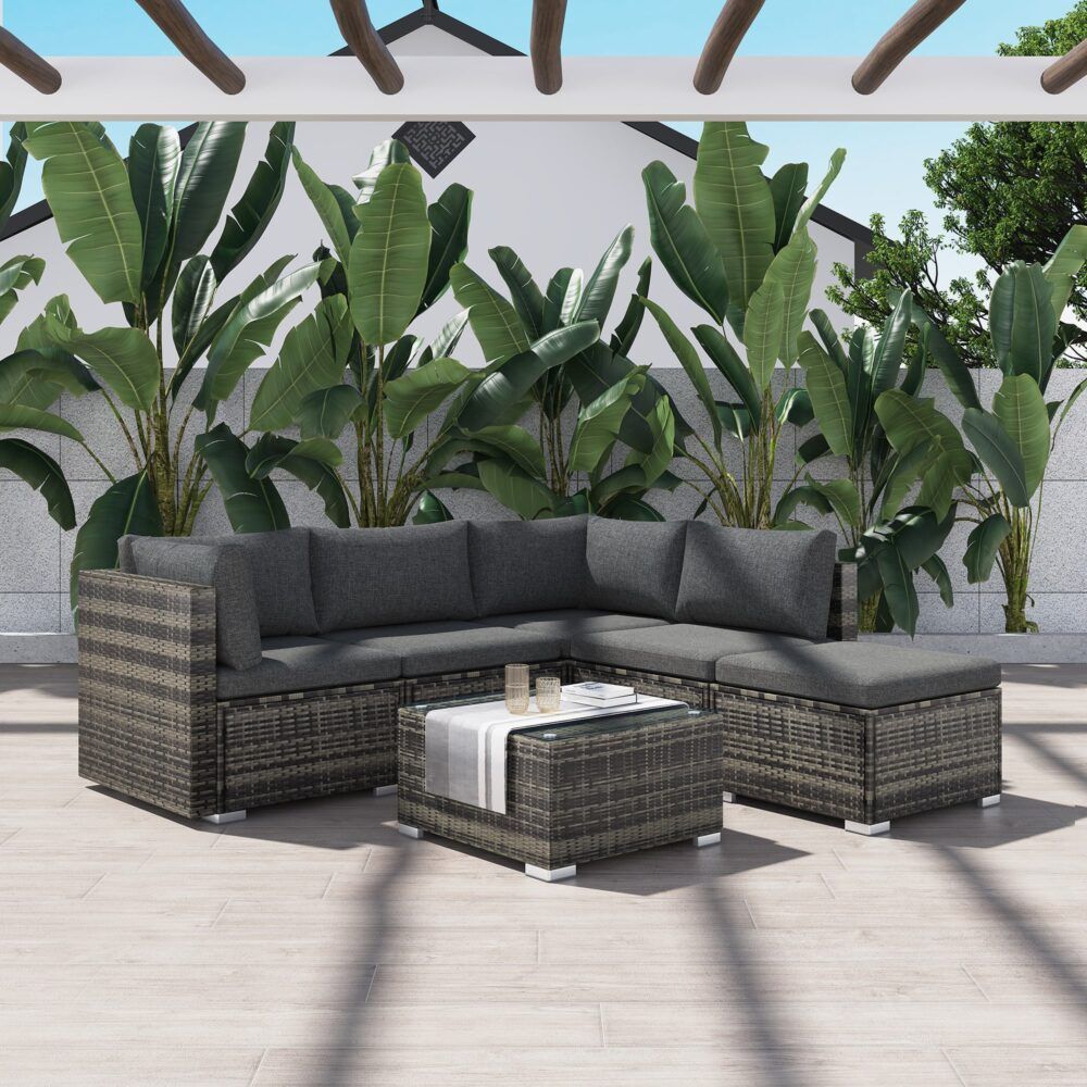 Outdoor ottoman-style corner sectional with grey cushions and woven ottoman coffee table