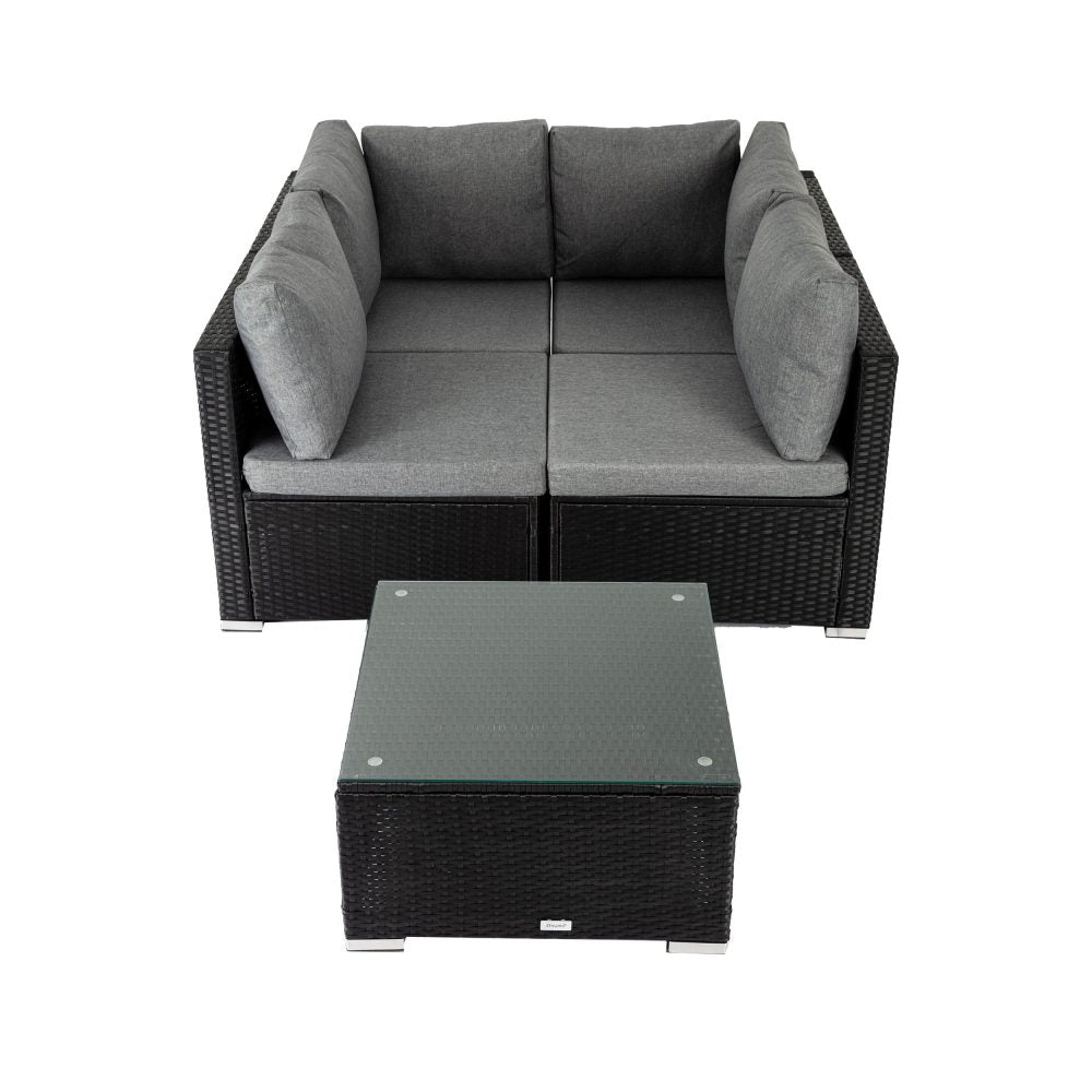 Outdoor modular lounge sofa set with gray cushions, black woven frame, and square glass coffee table