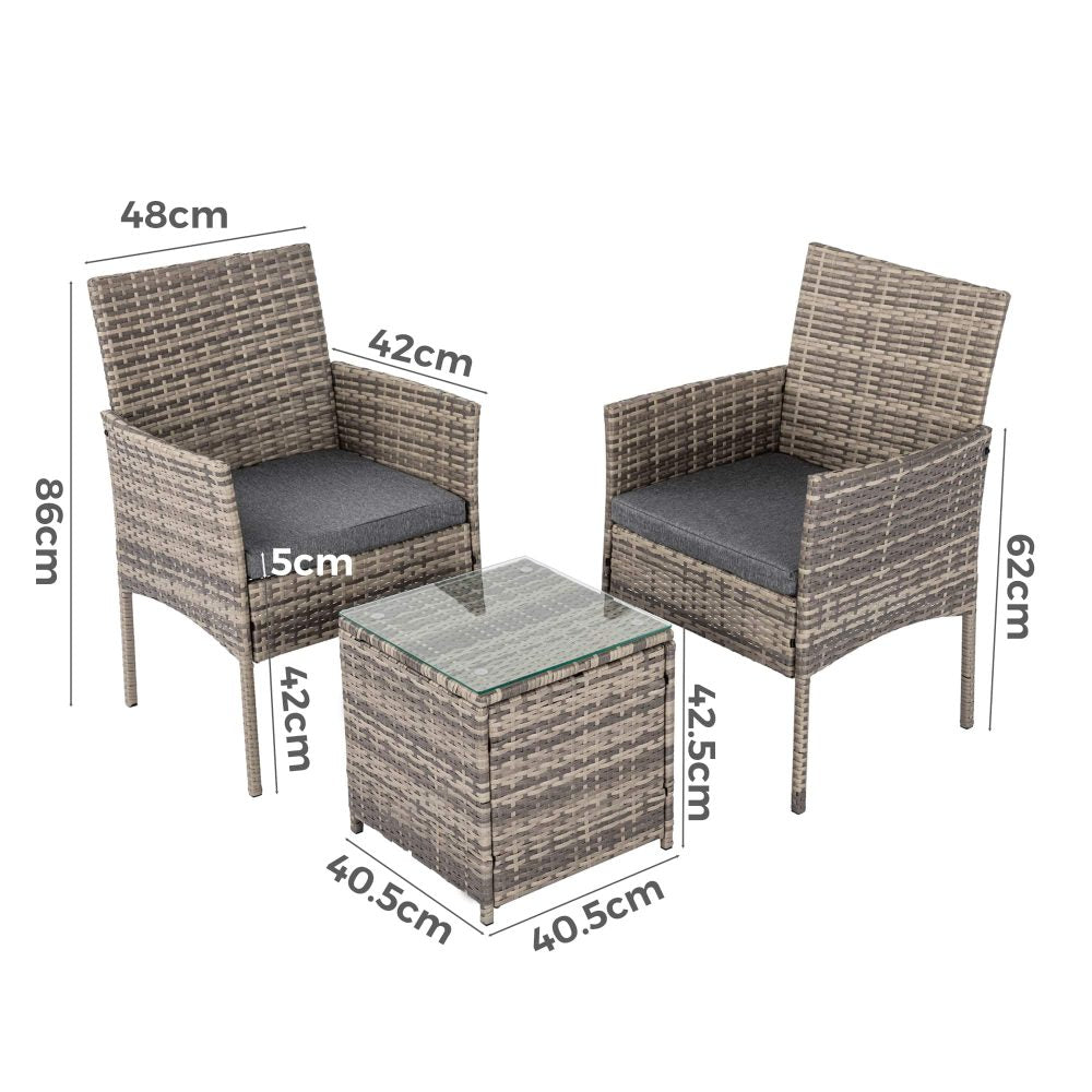 Two grey PE rattan armchairs and square side table with fitted dark cushions