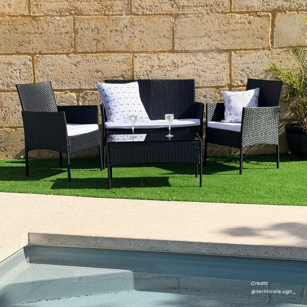 Dark wicker outdoor lounge sofa set with patterned cushions, loveseat, and glass-top table