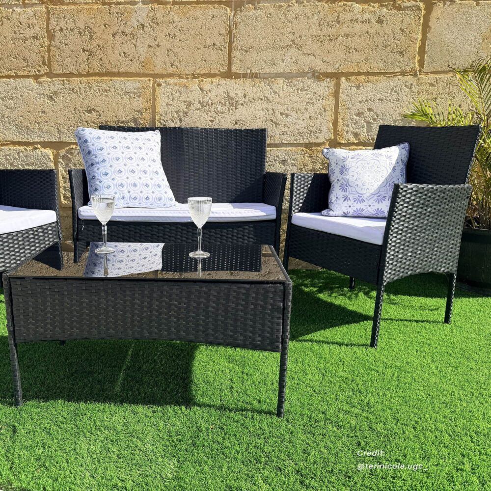 Dark wicker outdoor lounge sofa set with loveseat, armchairs, and glass-top coffee table