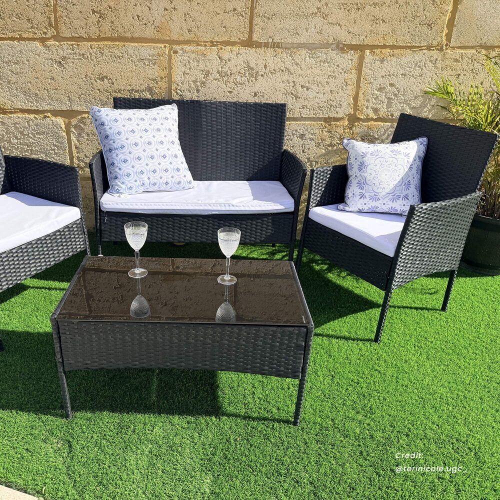 Dark wicker outdoor lounge sofa set with loveseat, two armchairs, and glass-top table