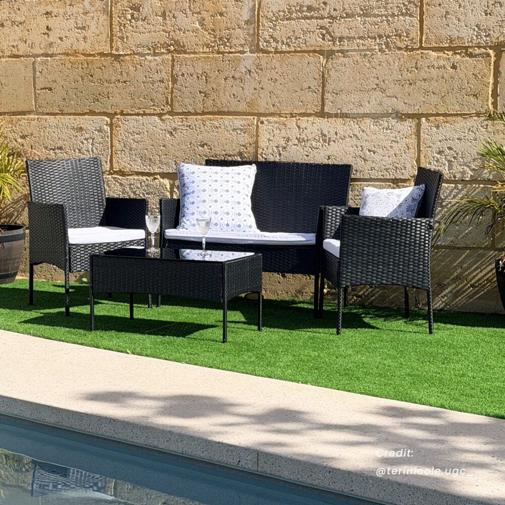 Dark wicker outdoor lounge sofa set with loveseat, armchairs, and glass-top table with drinks