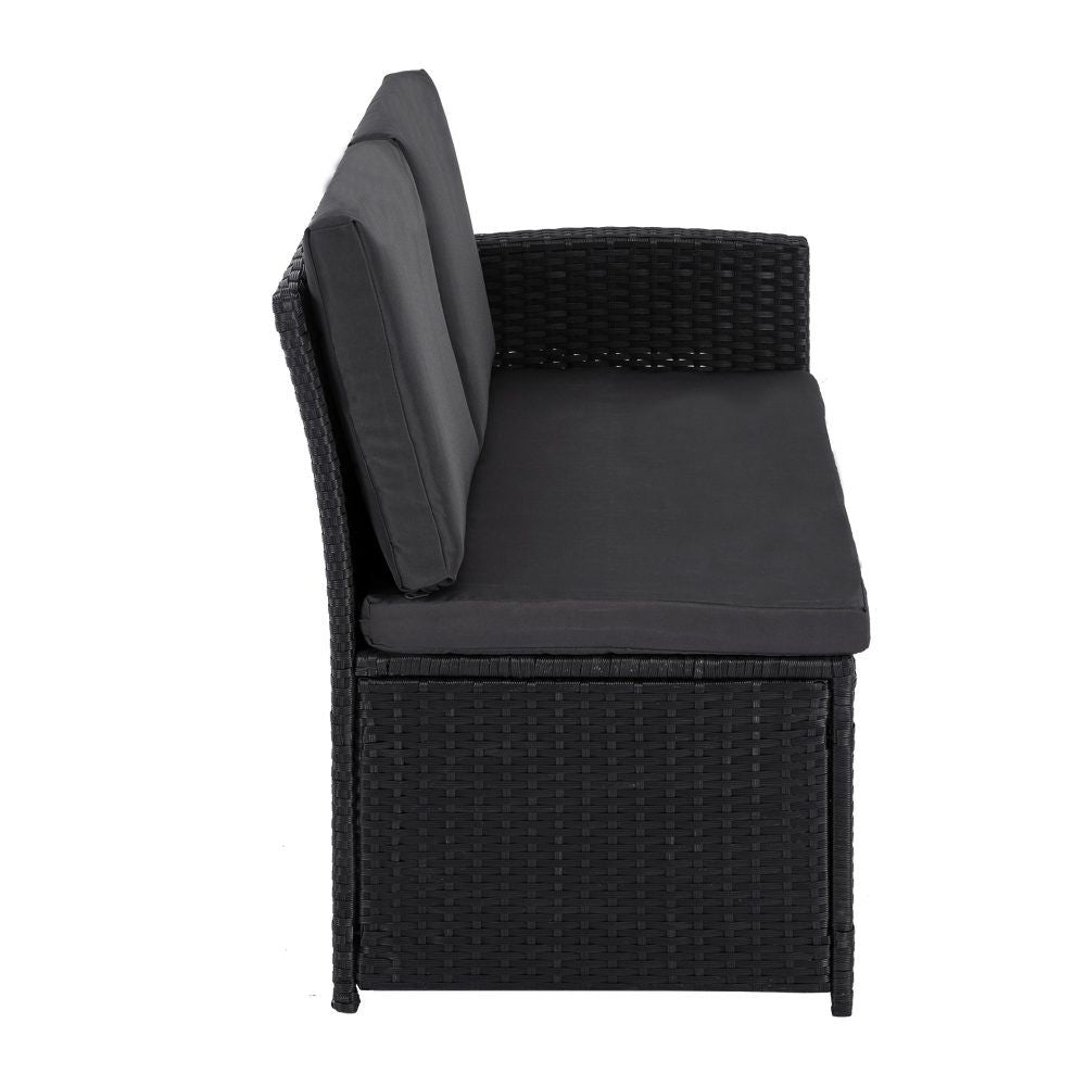 Black outdoor lounge chair with thick seat cushion, tall backrest, and woven base