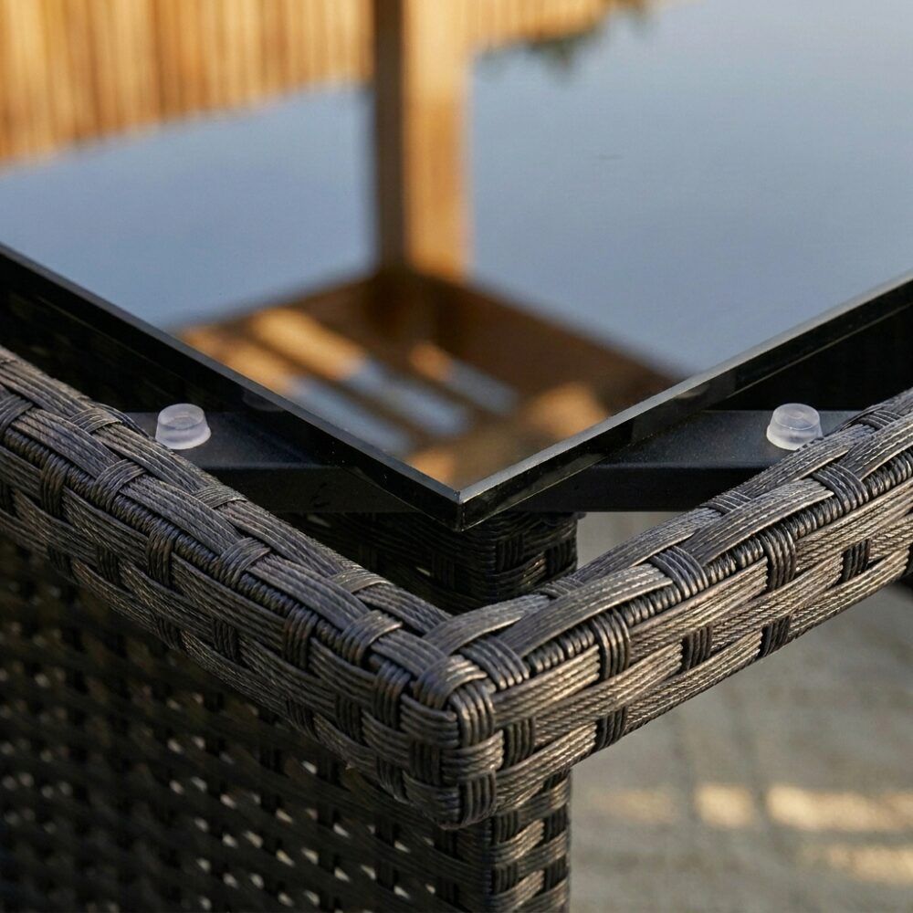 Black woven resin corner detail at tabletop edge and support frame