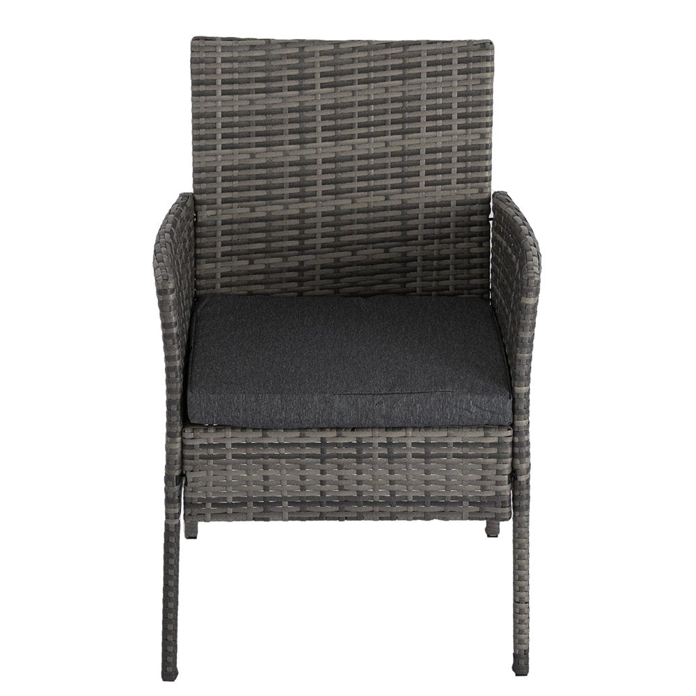 Grey wicker dining chair with dark seat cushion and woven backrest